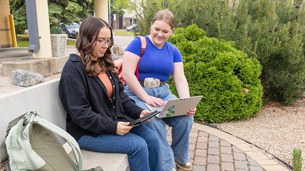 Students Outside On Laptop And Ipad 621X349 Students Outside On Laptop And Ipad 621X349